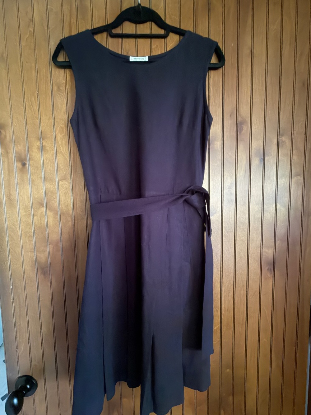 Women's black dress with tie belt.